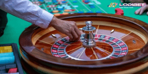 a casino dealer putting a the ball in the roulette wheel with chips and bets on the background